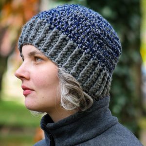 Kim wearing crocheted blue and gray hat