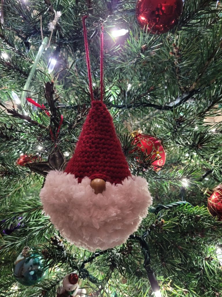 Gnome ornament hanging on a tree